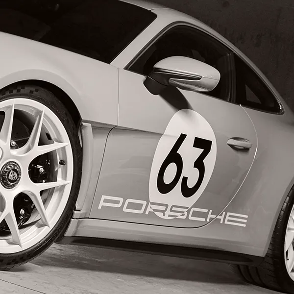 Detail of a Porsche 911 marked with a racing number, showing how meaning comes from purpose rather than quantity.