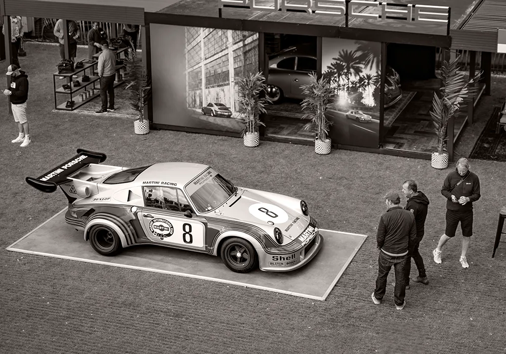 Historic Porsche 911 race car displayed in a controlled exhibition space, illustrating how context gives meaning to limited and iconic objects.