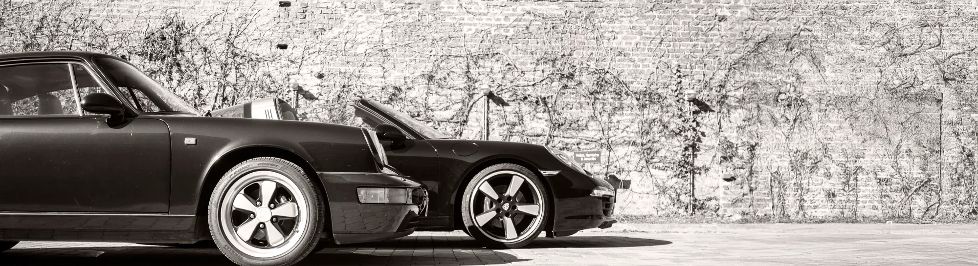 Silhouette of two generations of Porsche 911, showcasing the timeless profile that defines its identity.